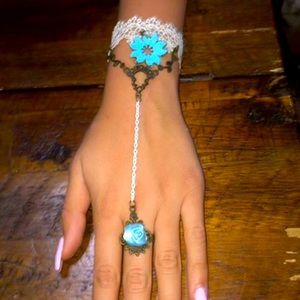 Blue and white bracelet attached with a ring